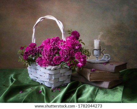 Still life with bouquet of pink roses in a basket	