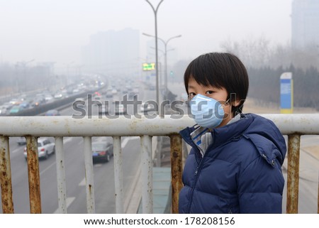 Asian boy wearing mouth mask against air pollution (Beijing) Royalty-Free Stock Photo #178208156