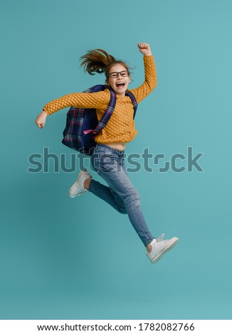 Back to school and happy time! Cute industrious child on color paper wall background. Kid with backpack. Girl ready to study. Royalty-Free Stock Photo #1782082766