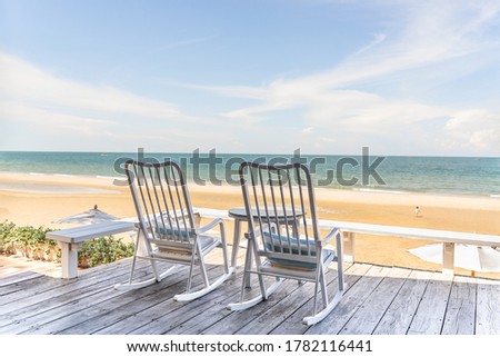 two rocking chairs at the terrace on beachfront on sunshine day at Thailand  Royalty-Free Stock Photo #1782116441