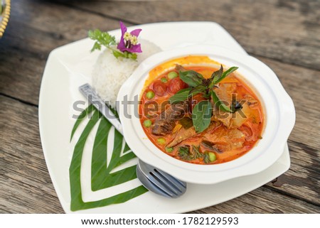 Thai Roasted Duck Red Curry with steamed rice decoration with banana leaf craft Royalty-Free Stock Photo #1782129593