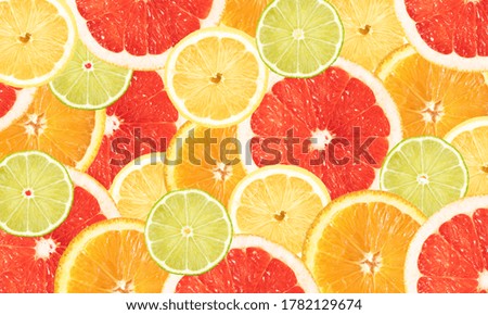 Bright banner with slices of citrus fruits - lemon, lime, orange and grapefruit. Advertising. Royalty-Free Stock Photo #1782129674
