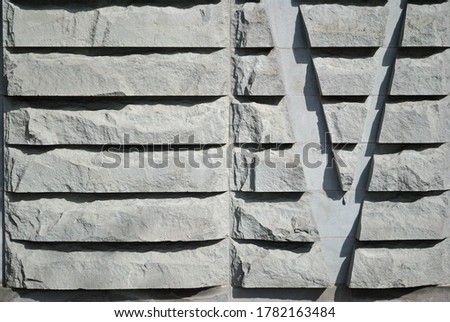 Wall with Roughly Carved Pattern & Letter V 
