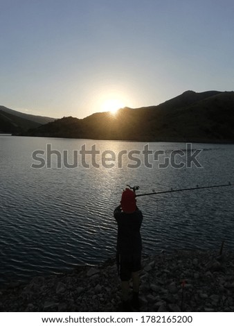 little boy fishing with his fishing rod

