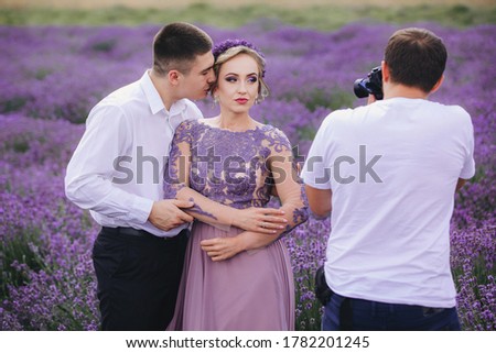 professional photographer takes picture of couple in love in field of lavender. love story on summer day