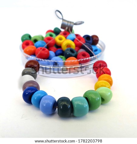 String of of colorful glass beads for crafting and jewelry making. DIY kit, crafting with children. Hobby, handmade jewelery. Royalty-Free Stock Photo #1782203798
