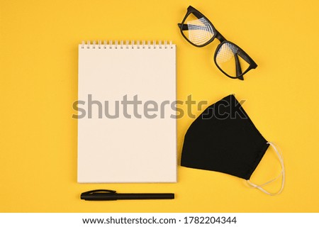 black glasses and mask on flat lay