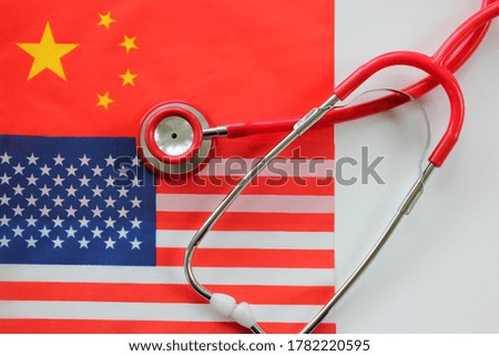 United States of America flag and China flag with stethoscope. Relationship between USA and China concept. Top view. 