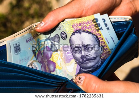 Hands holding and showing wallet with romanian money LEI. Royalty-Free Stock Photo #1782235631