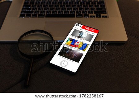Modern smart phone with business news article isolated on white.