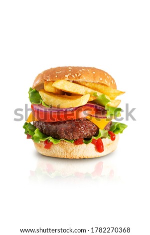 Fresh juicy beef hamburger with dripping ketchup and french fries isolated on white background with reflection