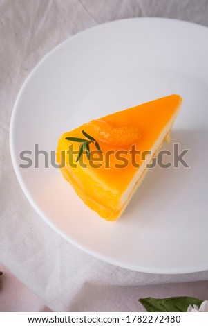 Orange sherbet layer cake top with slice orange