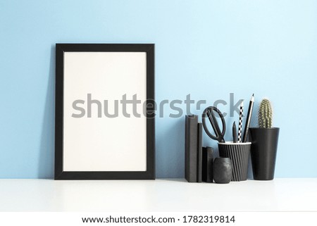Poster frame mockup and office stationery.