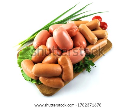 Sausages on chalkboard isolated on white. stock image
