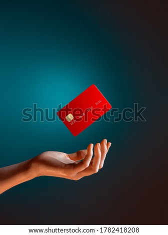 Close up female hand holds levitating template mockup Bank credit card with online service isolated on blue background