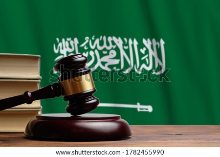 Justice and court concept in Kingdom of Saudi Arabia. Judge hammer on a flag background. Royalty-Free Stock Photo #1782455990