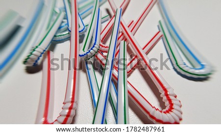 Multicolored straws for juice on a white table