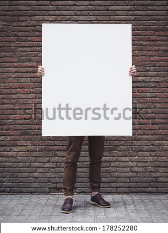 Man holding blank poster