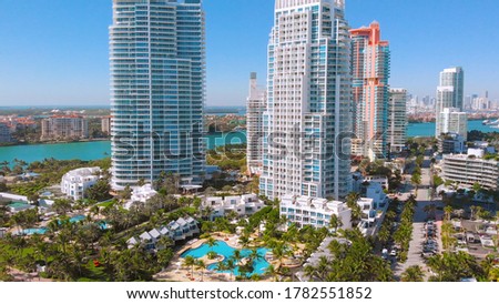 Close up drone view Of Miami Beach, hotels and skyscrapers near South Pointe Beach and coastline, Florida Beaches, Resort Cities, City Landscape. Downtown Miami in the background of white skyscrapers.