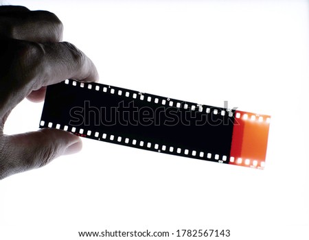 Color negative film 35mm, Photographic film top view in darkroom.