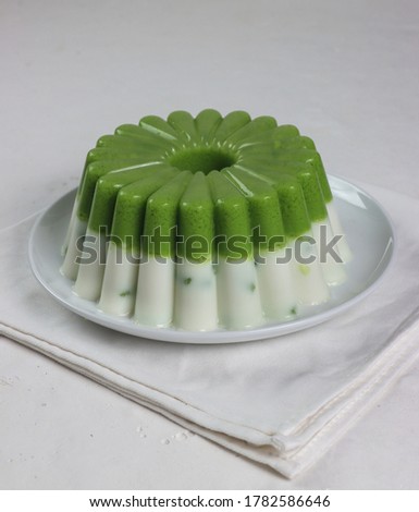Two layer puding pandan cendol, traditional pudding dessert from Indonesian. made from rice fLour and pandan juice. Refreshing for break fasting during ramadan. Served at the Table, Isolated Picture