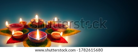 Happy Diwali, Diya oil lamps lit on colorful rangoli with copy space Royalty-Free Stock Photo #1782615680