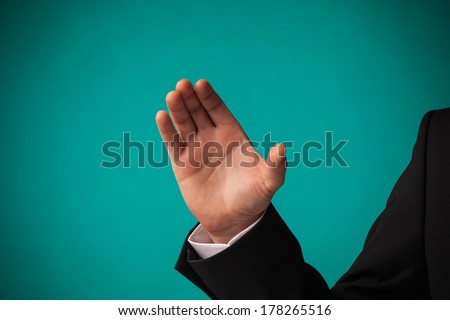 bright picture of businessman holding imaginary object, over green background
