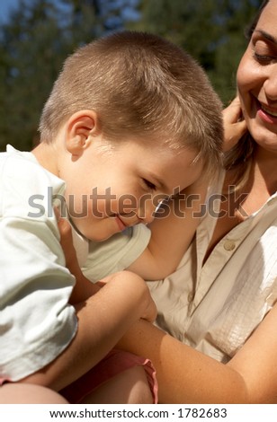 portrait of lovely boy in mother's hands
