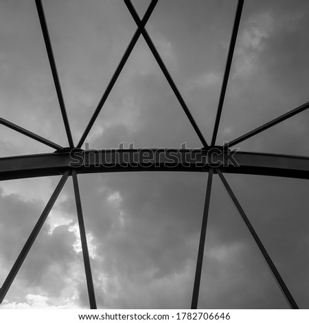 Part of steel bridge against the sky. Abstract picture of industrial construction against a dramatic sky.