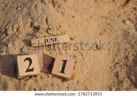 June 21, Number cube with Sand background.	