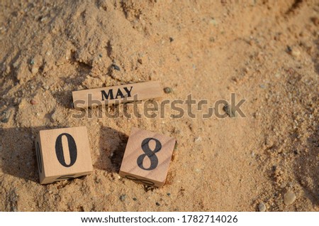 May 8, Number cube with Sand background.	