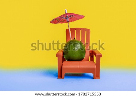 Creative, minimal summer layout concept made of lime, lounge chair and sun umbrella on colours background