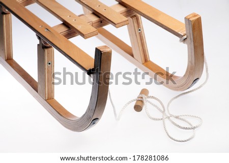 Color picture of a vintage wooden sledge isolated on white