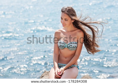Beach woman laughing having fun in summer vacation holidays.