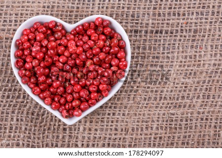 pepper in  cup in the shape of heart on sack  cloth