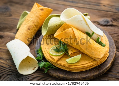 Different kinds of tortillas on the wooden table