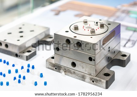Plastic injection metal mold production from manufacture by high precision and quality cnc machining center material made from steel with plastic sample part Royalty-Free Stock Photo #1782956234