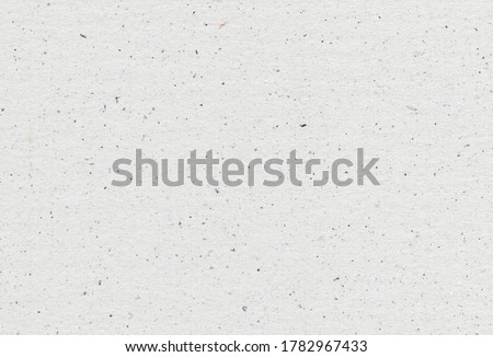 Close of view of grey paper recycled background with inclusions of paper particles. Extra large highly detailed image. Recycled paper concept.