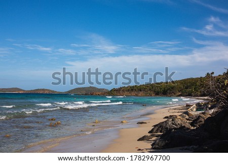 A wide shot of Zoni Beach overlooking the Caribbean sea from a shady spot in the sand, in Culebra, Puerto Rico