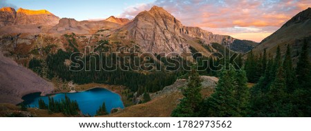 A brilliant sunrise at the lower Blue Lake in Mount Sneffels Wilderness, Ridgeway, Colorado during the falls season. A backpacking adventure.  Royalty-Free Stock Photo #1782973562