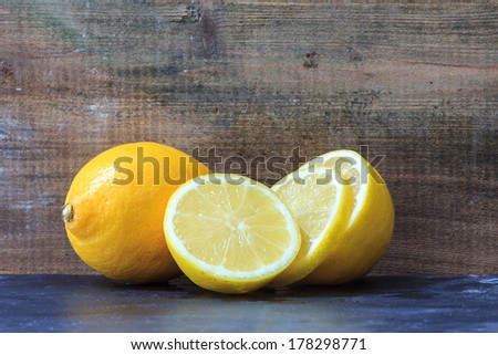 A sliced fresh lemon in front of wood
