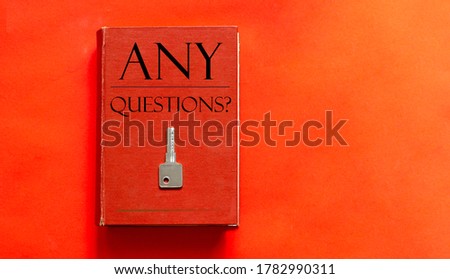 red book with text ANY QUESTIONS and a key on a red background
