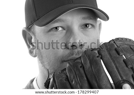 Baseball Player - This is a black and white photo of a young man wearing a baseball cap and looking out over his glove. Shot on an isolated white background and processed slightly to enhance detail.