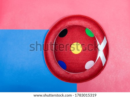 colorful clown hat on blue and red background.