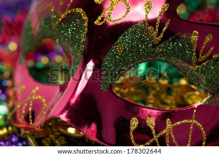 Colorful Mardi Gras Mask with beaded background