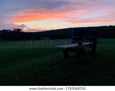 Beautiful sunset with lonely bench