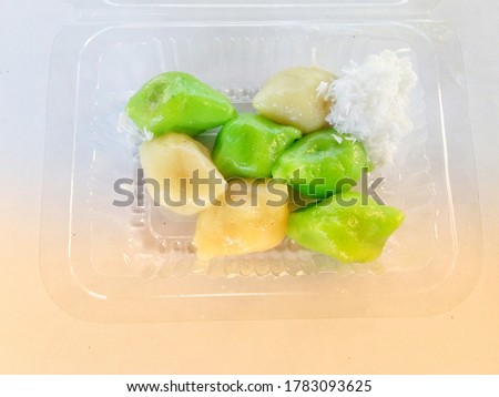 Photo of kelepon food on white and yellow background
