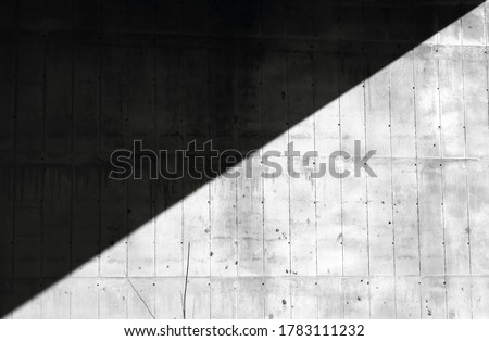 Architectural background with detail of a concrete partially shaded bridge pillar