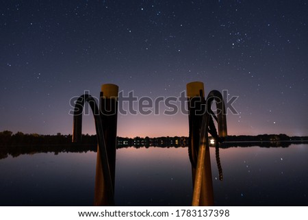 Starry sky at the harbor with jetty