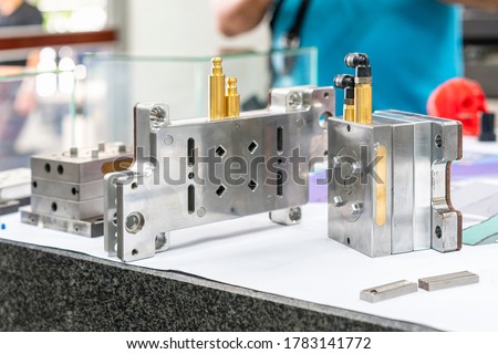 Plastic injection metal mold production from manufacture by high precision and quality cnc machining center material made from steel with cooling hose connector Royalty-Free Stock Photo #1783141772